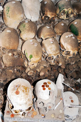 A heap of bones and skulls placed against the walls bones inside an ancient underground cemetery commonly named “Fontanelle” in Naples, Italy