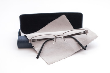 Glasses and case with glasses cleaning cloth on white background