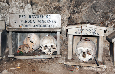 The votive box for devotion toward the chosen skull inside the ancient “Fontanelle” cemetery,...
