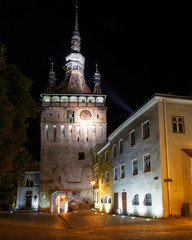 Naklejka na ściany i meble Night scene with the tower clock of the medieval town of Sighisoara, in Romania
