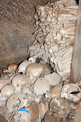 A heap of bones and skulls placed against the walls bones inside an ancient underground cemetery commonly named “Fontanelle”  in Naples, Italy
