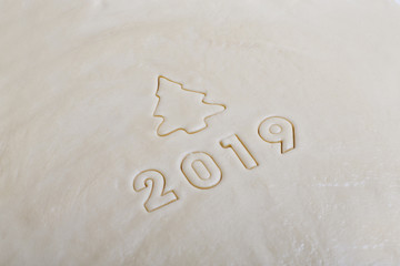 the inscription in the form of 2019 on the raw dough, imprinted from molds for biscuits. The symbol of the coming 2019.