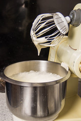 A boy in the kitchen kneading a dough for chocolate cupcakes