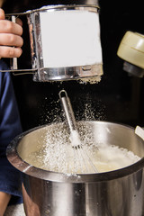 The process of kneading dough in an iron bowl