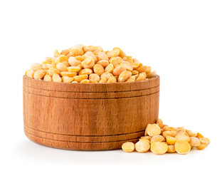 Dry peas in wooden plate on a white background. Isolated.