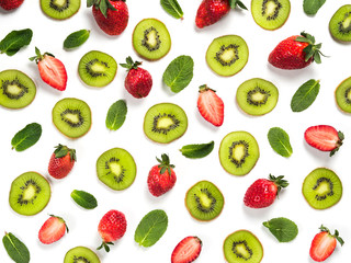 Kiwi fruit slice, strawberry and mint leaves on white. Colorful food pattern for background. Isolated on white. Top view or flat lay.