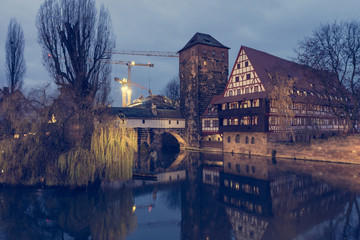 Night view of medieval bridge crossing a river.
