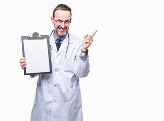 Middle age senior hoary doctor man holding clipboard isolated background very happy pointing with hand and finger to the side