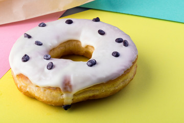 donut with white icing on a colorful background