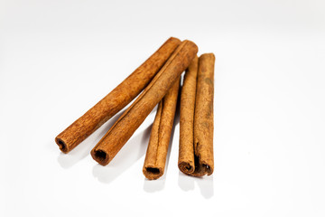 Cinnamon isolated on white reflective surface