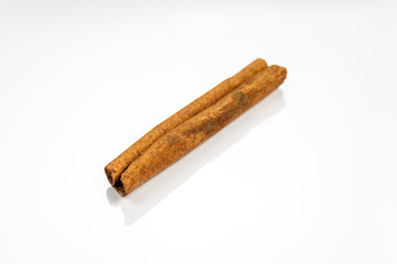 Cinnamon isolated on white reflective surface