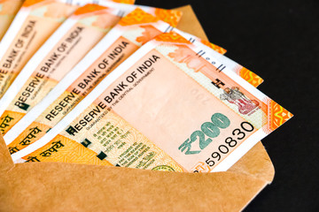 Close up view of envelope with brand new indian two hundred rupees banknotes.