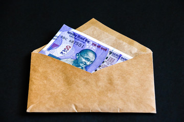 Close up view of envelope with brand new indian one hundred rupees banknotes.