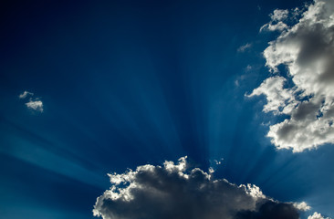 Clouds, sun rays and blue skies