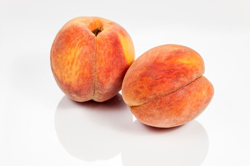 Peach isolated on white reflective background