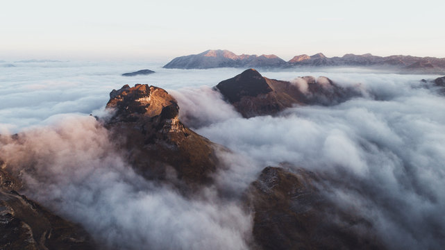 Clouds hovering over mountains