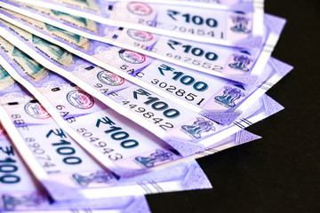 Close up view of brand new indian one hundred rupees banknotes.