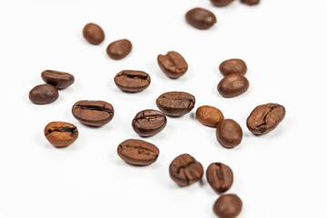 Roasted coffee beans isolated on white background, angle view