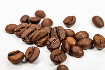 Roasted coffee beans isolated on white background, angle view