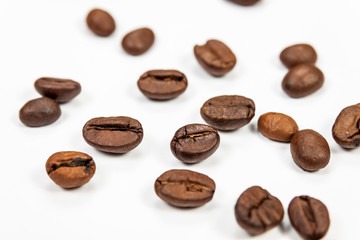 Roasted coffee beans isolated on white background, angle view