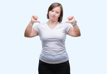 Young adult woman with down syndrome over isolated background looking confident with smile on face, pointing oneself with fingers proud and happy.