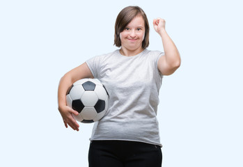 Young adult woman with down syndrome holding soccer football ball over isolated background...