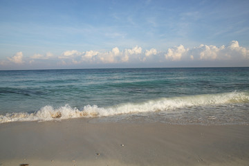 blue sea with a foam wave on the beach with white sand and blue sky with clouds on the horizon. Summer concept background - Sea or Ocean Beach Wallpaper, postcard