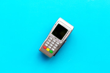Payment terminal, compact POS terminal on blue background top view space for text