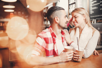 Happy young couple dating in cafe, drink coffee.