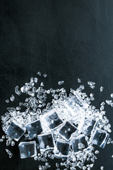 pile of ice cubes on black bar table top view mock-up