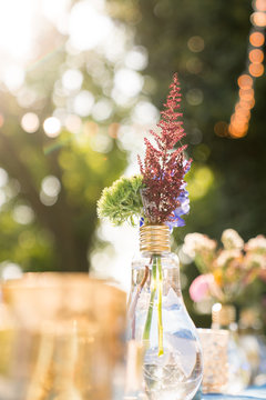 Florals in lightbulb as centerpiece decor on a table. 