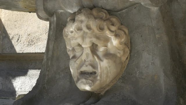 Fountain feature of eroded face at the Quattro Canti or Four Corners in Palermo, Sicily, Italy. Handheld stabilized shot.