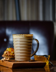 Cappuccino, sweets and fruits. Dark wooden background with text area for design menu restaurant.