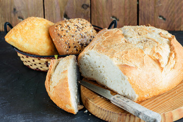 Loafs of bread on the table of the rustic kitchen.