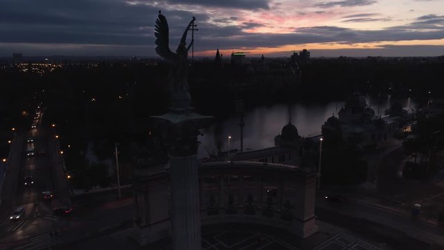 Aerial fly over Archangel Gabriel monument in Budapest. Square of Heroes. Early sunset