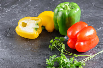 Bell peppres and parsley on the black background.