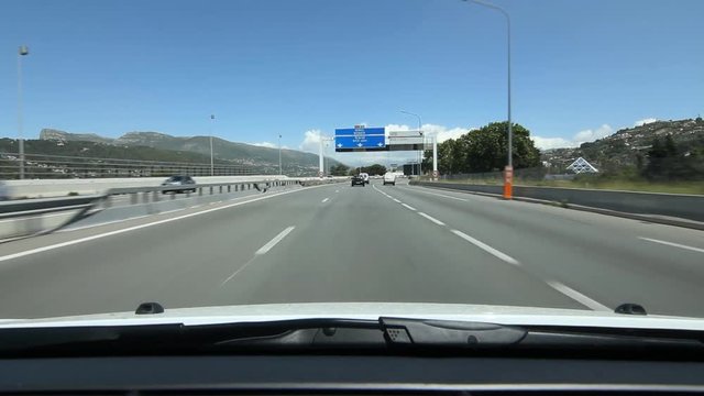 Driving north on highway A8 in Nice, France. Signs for Monaco and Nice.