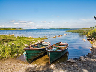 Wooden boats moored up on the edge of the lake