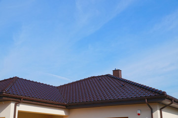 A newly built residential house. A fragment of the roof made of ceramic tiles.