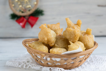 Tipical christmas Italian food called pettole on light wooden background