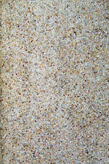 Gray stone mosaic on the sidewalk, building and industrial background, decorative material, texture