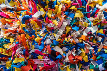 Scraps of colorful fabric in a full frame close-up abstract background