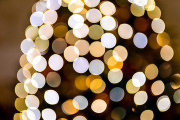 Christmas home room with tree and festive bokeh lighting, blurred holiday background