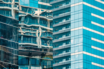 light reflecting in the glass windows of modern tall office blocks creating interesting contemporary abstract patterns