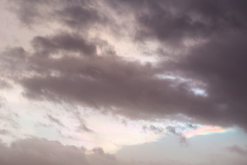 Colorful vibrant sunset sky with rainbow-like effect in the clouds