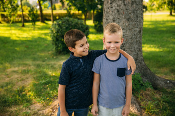 Fototapeta premium Happy children in park. Two brothers. Ten year old