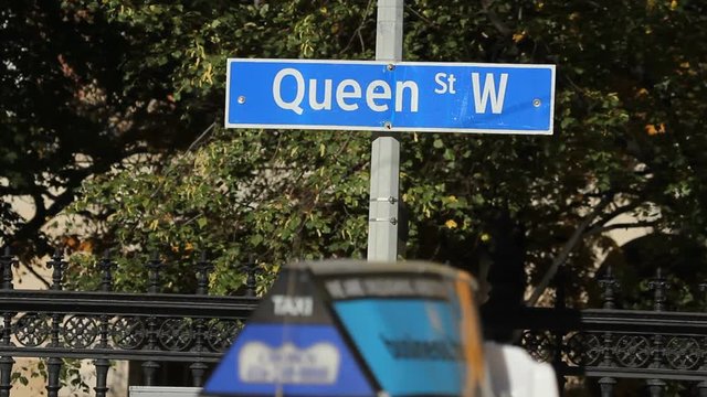 Queen Street West Sign With Traffic And Streetcar. Toronto, Canada.