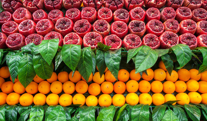 ripe juice fresh pomegranate and orange fruits cut in half prepared squeezed drink in street and bazaar