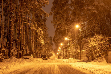 Center of the snowy road. The night city full of snow.