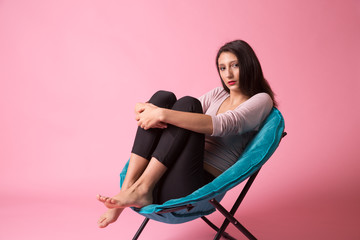 Teen Brunette sitting on a blue chair